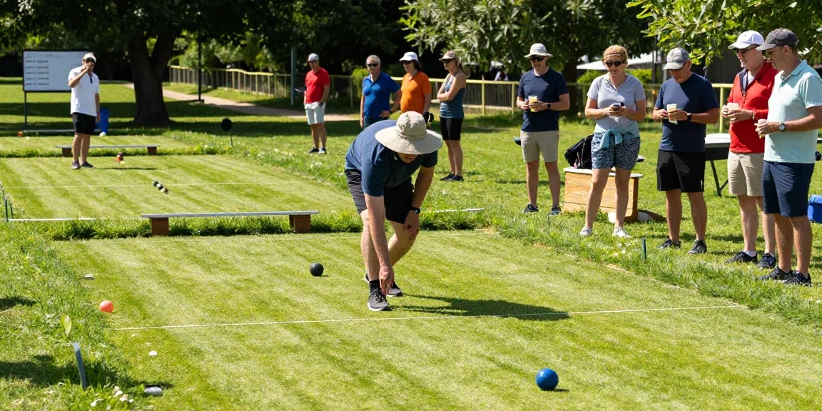 Engaging petanque match at fopikotapontiana.org with players focused on the court in sunny outdoor setting.